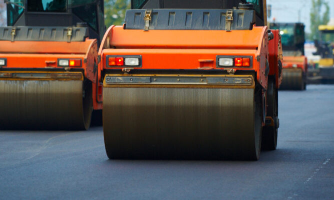 Fleet of construction vehicles heading to an asphalt job