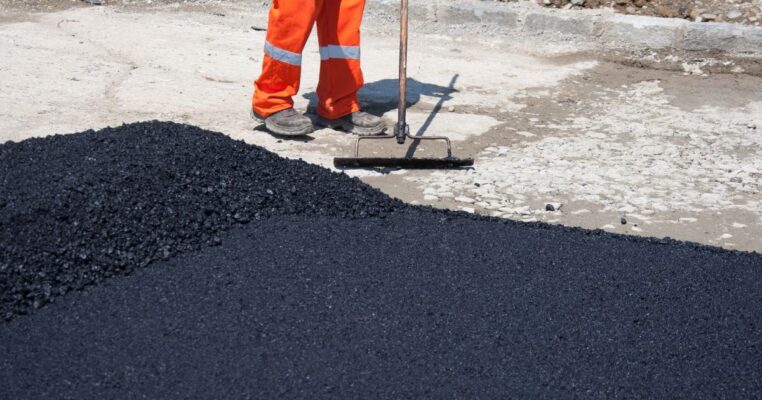 Worker working with asphalt
