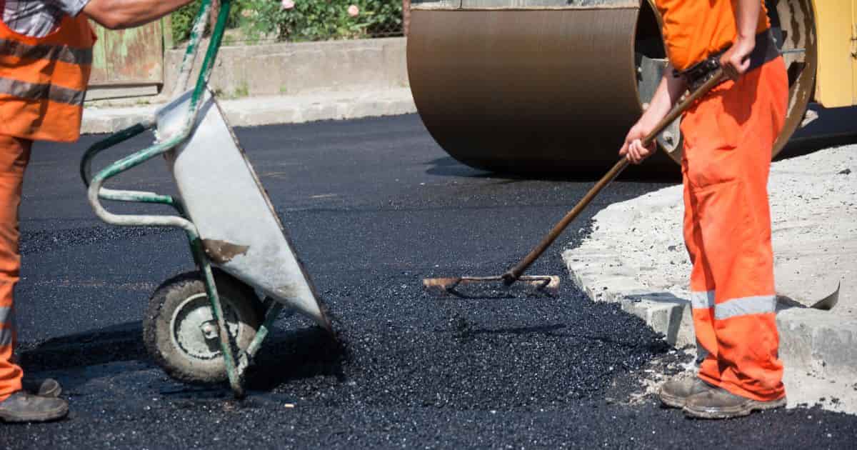 Workers repairing asphalt