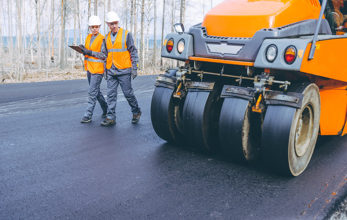 roller road repair work at residential pavement by asphalt paving contractor
